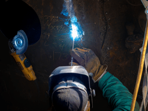 A welder installs new circle plates on a removed miter gate aboard the Henry M. Shreve floating heavy crane at Hannibal Locks and Dam in Hannibal, Ohio, September 13, 2024.