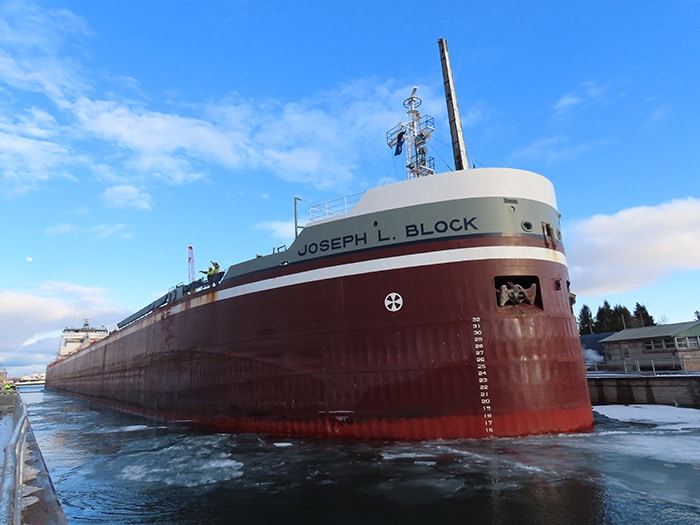 The Joseph L. Block is the first ship through the Soo Locks in Sault Ste. Marie, Michigan for the 2024 season opening on March 22, 2024. At high pool, the Block waits as the gates open and a lock and dam operator stands by to cast of the mooring lines.